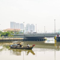 Man rowing boat in one of the rivers of Saigon, Vietnam