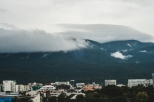 Clouds over mountains and city