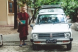 Buddhist monk entering a car
