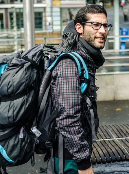 Micael Nussbaumer, world traveler and freelancer, with his regular backpack - tucked between his back and it is the smaller photography backpack